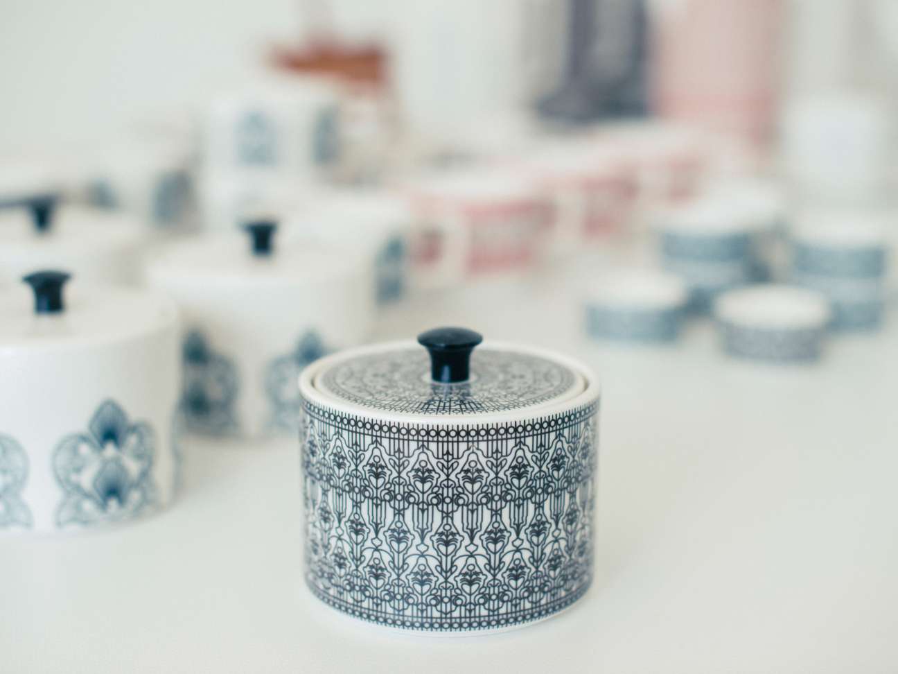 Ceramic container with ornate blue patterned design and black lid from Vaja Finland.