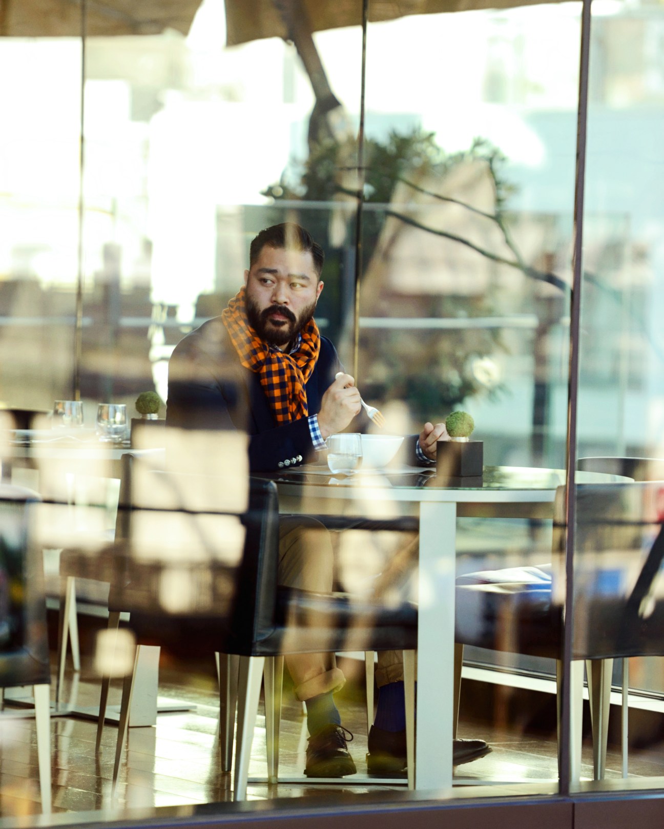 Man in Louis Vuitton jacket and scarf dining alone at Bulgari Il Café in Tokyo.