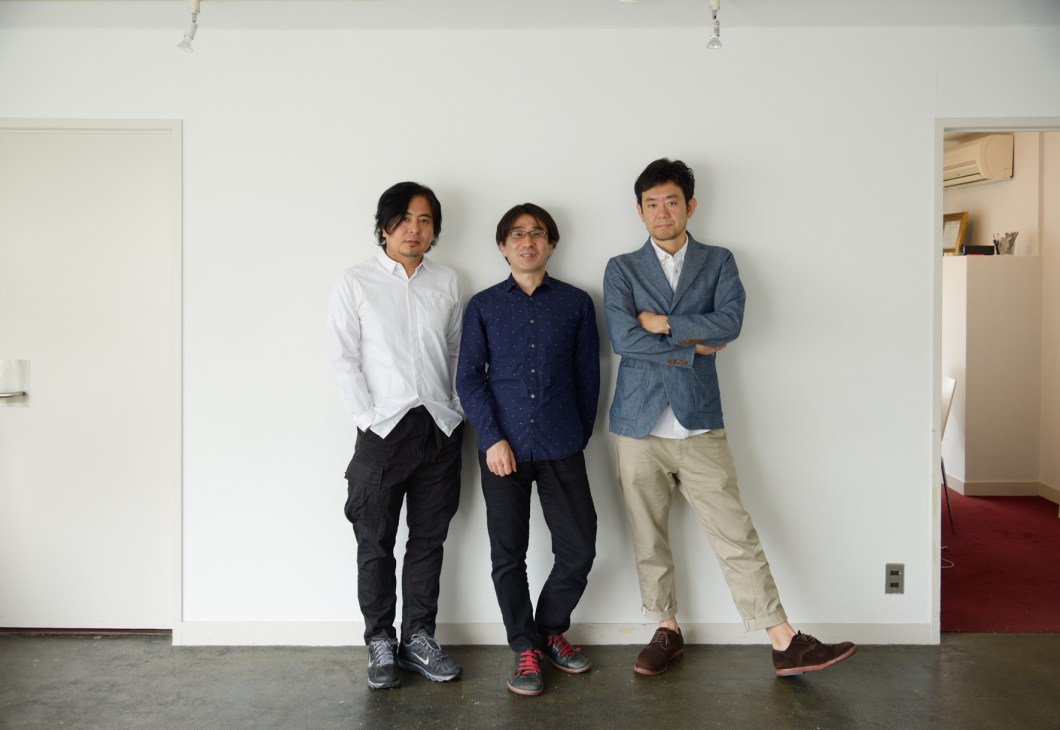 Three men standing against a white wall in an office space: Hiroya Yoshizato, Masataka Baba and Atsumi Hayashi, co-founders of Real Tokyo Estate.