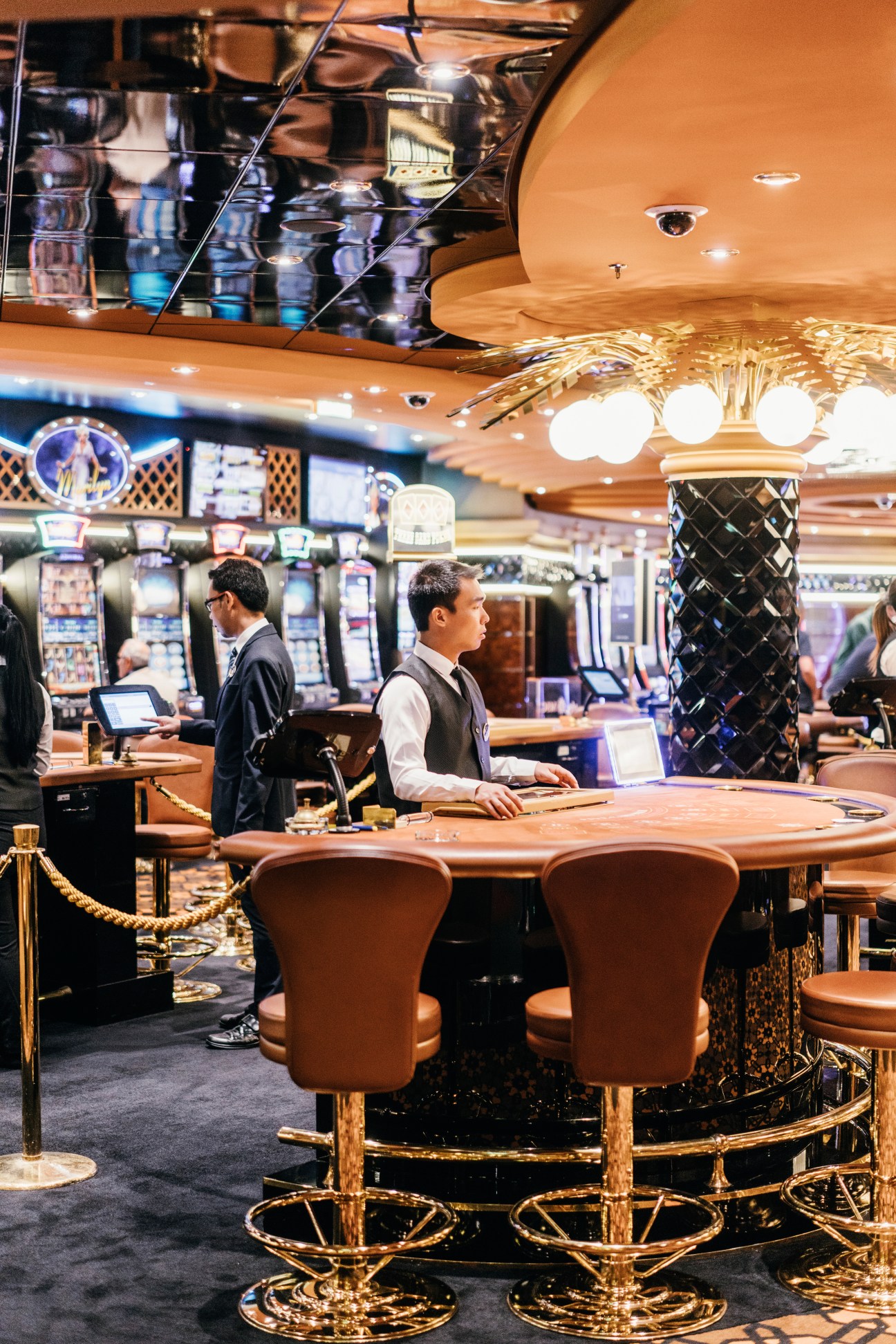 Interior of Millennium Star casino on MSC Preziosa with gaming tables, slot machines, and staff.