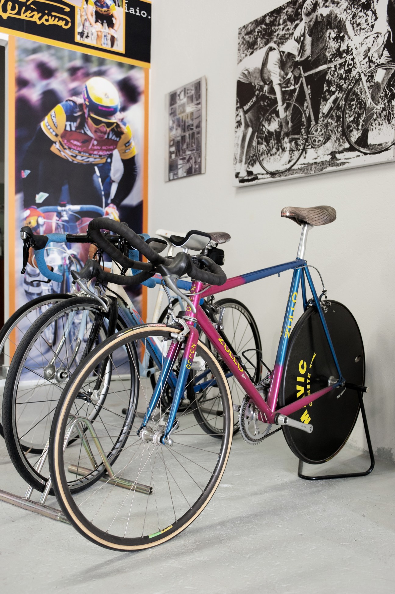 Phil Anderson's 1988 lo-pro bicycle displayed in a workshop with cycling memorabilia on the walls.