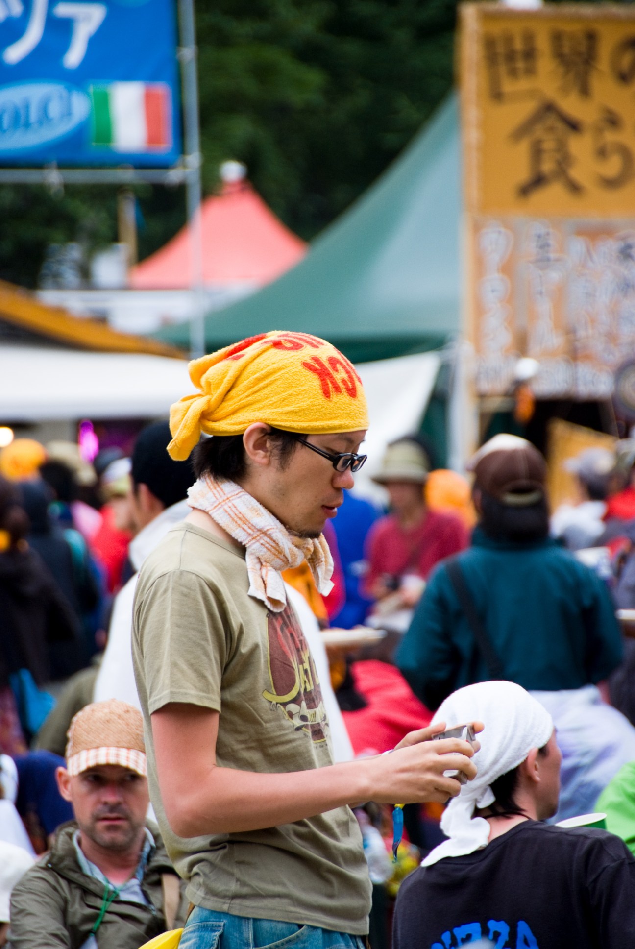 Festival attendee wearing bright yellow headwrap and glasses at Fuji Rock Festival.