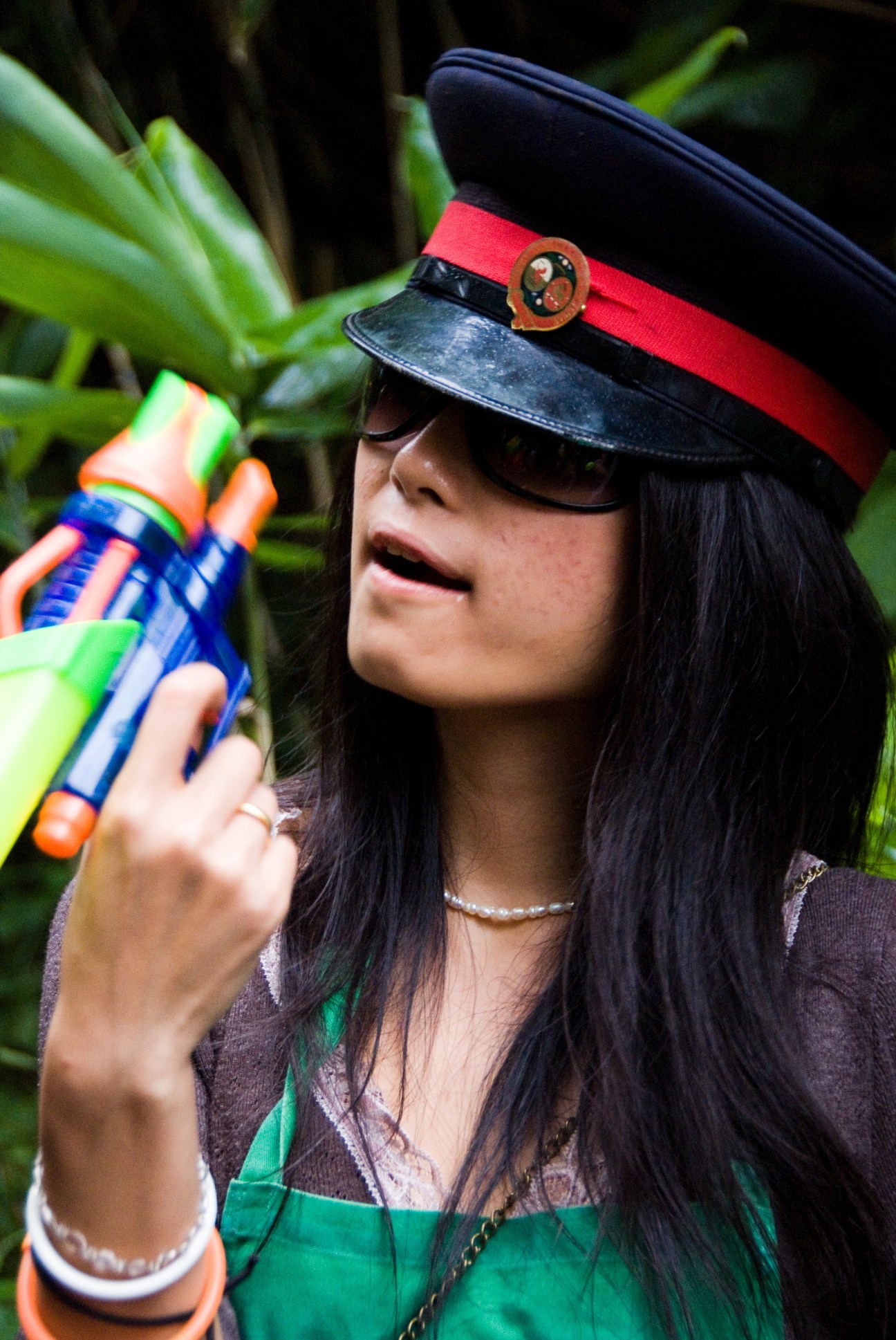 Woman in captain's hat holds a colorful toy rum pistol at Fuji Rock festival