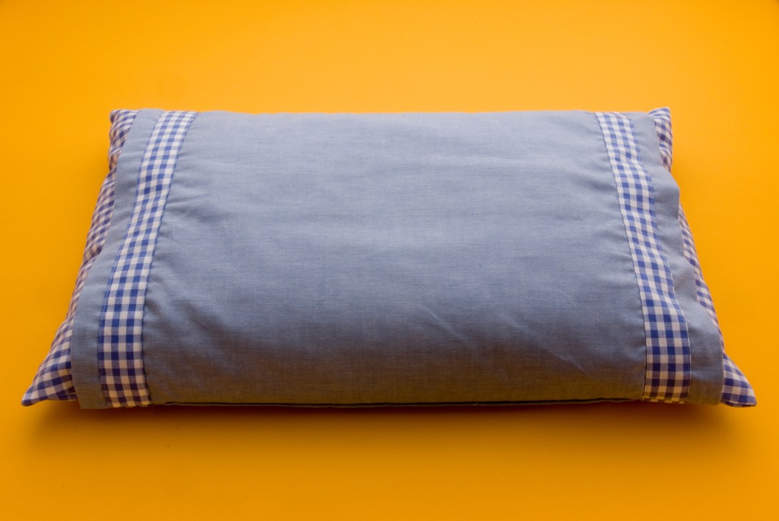 Nishikawa Living buckwheat pillow with blue and white gingham trim on yellow background