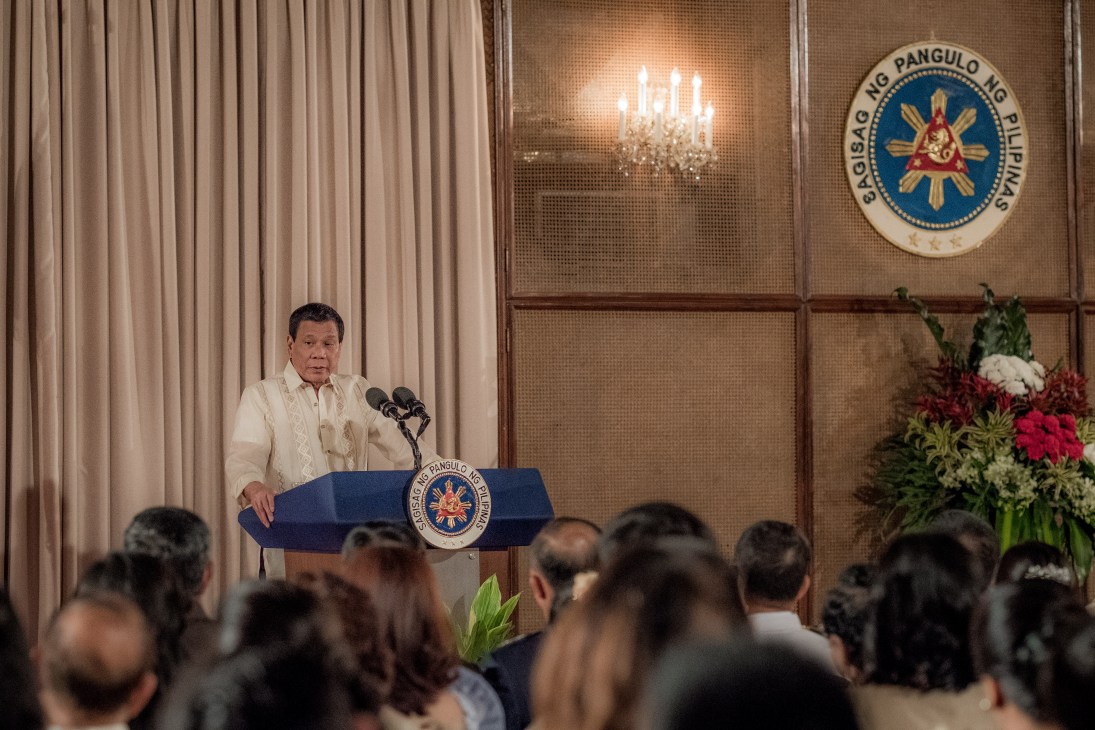 President Rodrigo Duterte speaking at a lectern during an armed forces oath-taking ceremony at Malacañan Palace in Manila.