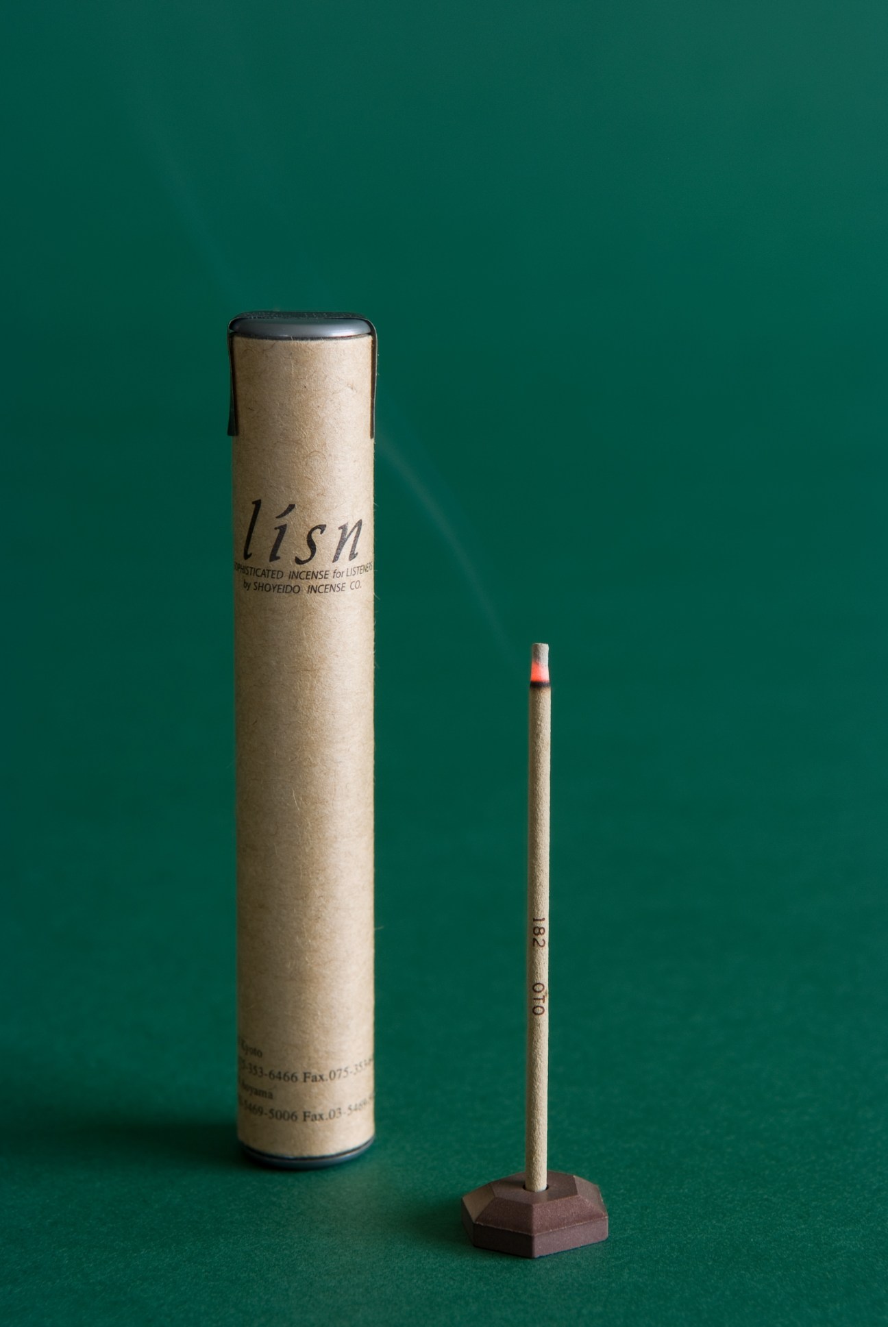 Lisn incense stick with holder against teal background