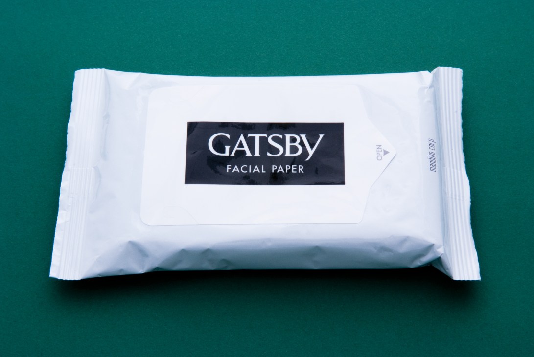 Package of Gatsby facial paper wipes on teal background