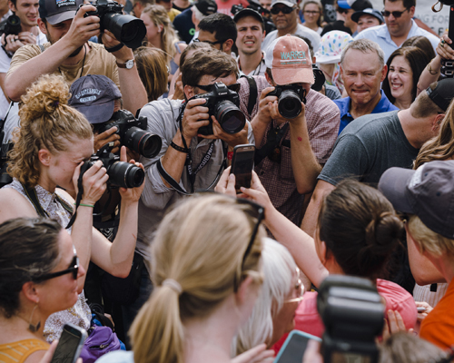 Crowd of journalists and camera operators gathered around a political event at Iowa State Fair
