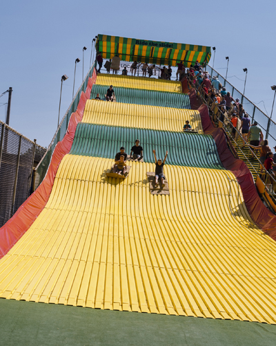 People riding down the Giant Slide on burlap sacks at Iowa State Fair