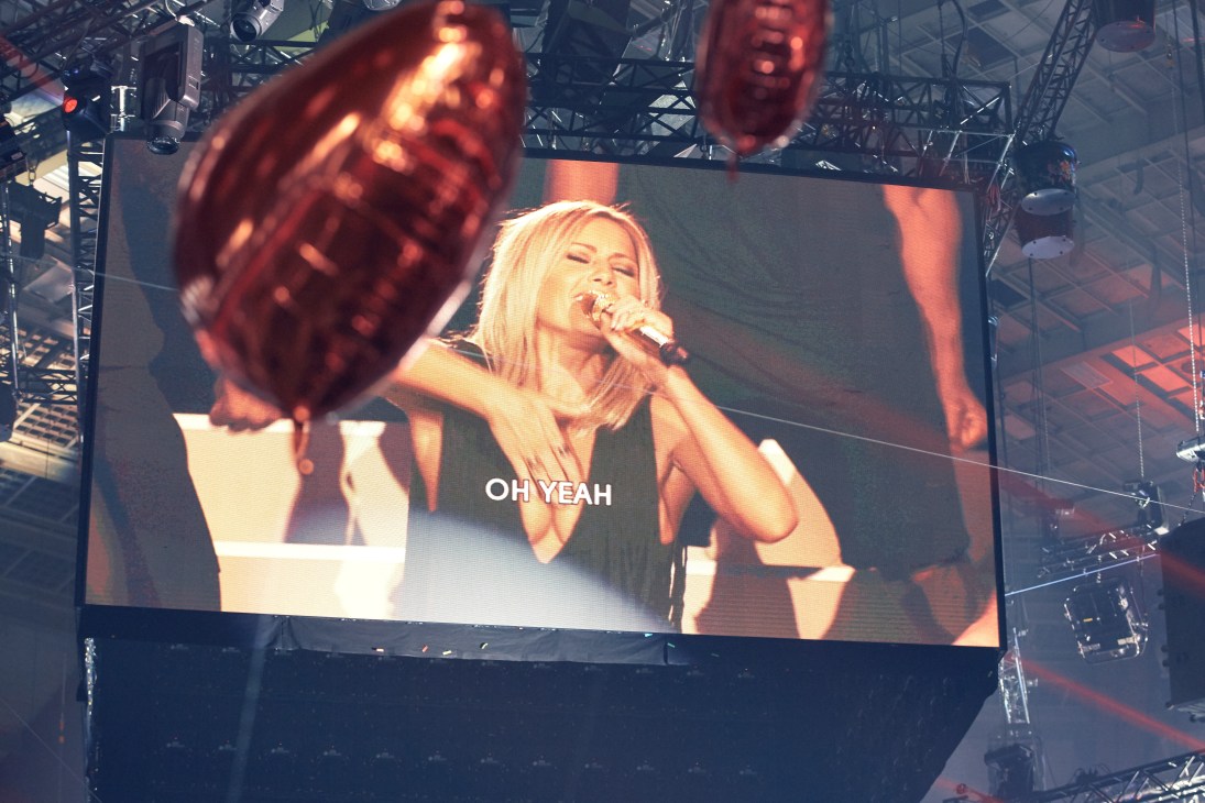 Helene Fischer singing into a microphone on stage, displayed on a large screen at Schlagerbooom concert.
