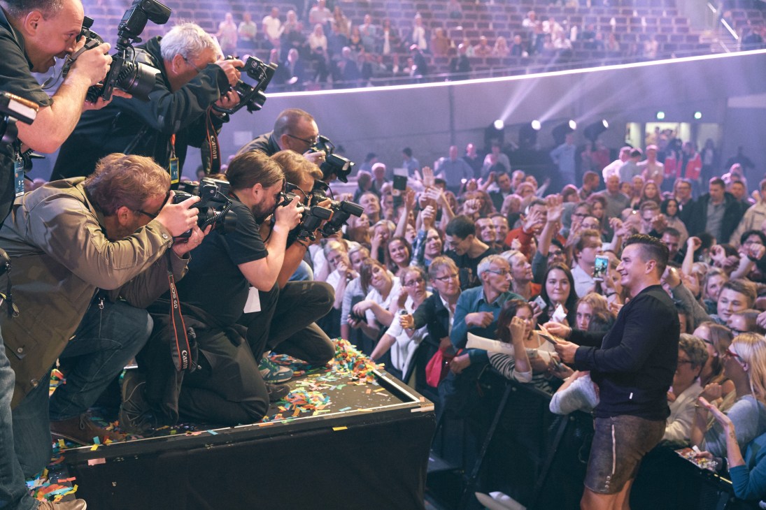 Camera operators filming Andreas Gabalier performing on stage at Schlagerbooom concert in Dortmund.