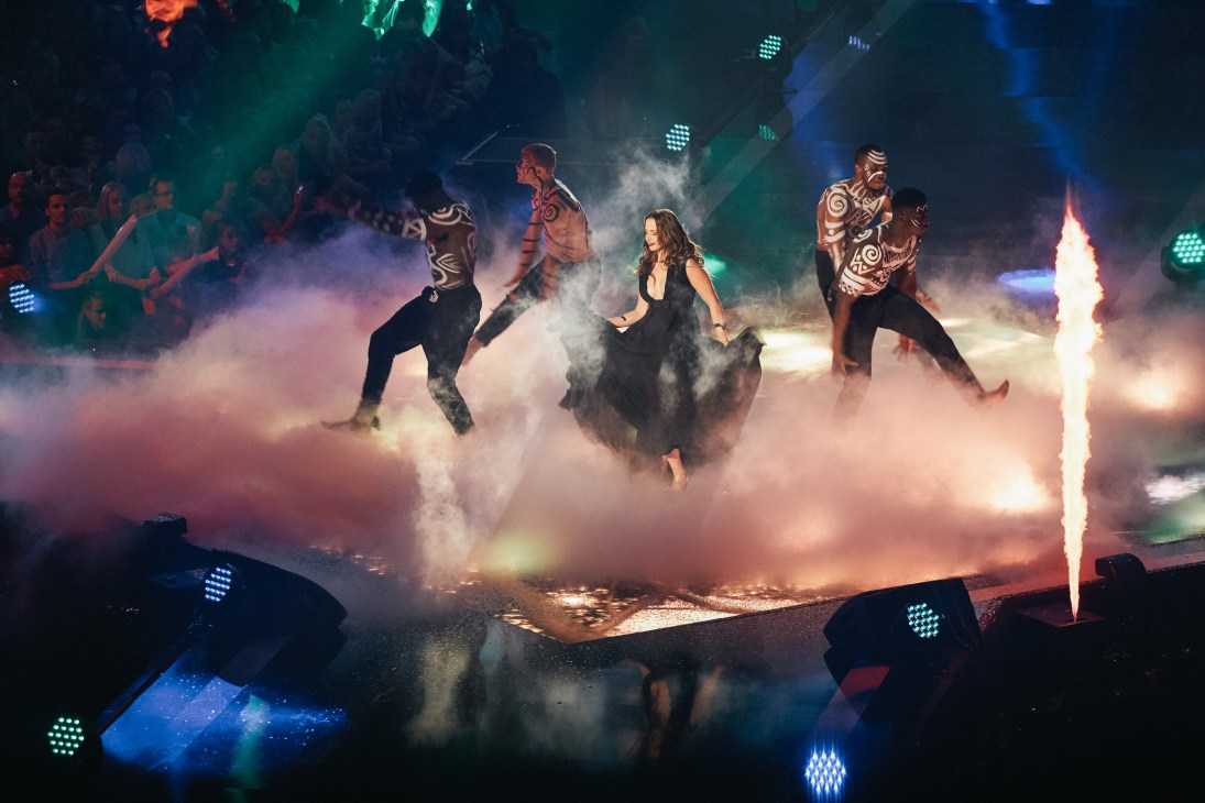 Performers on stage surrounded by smoke and pyrotechnics at Schlagerbooom concert in Dortmund.