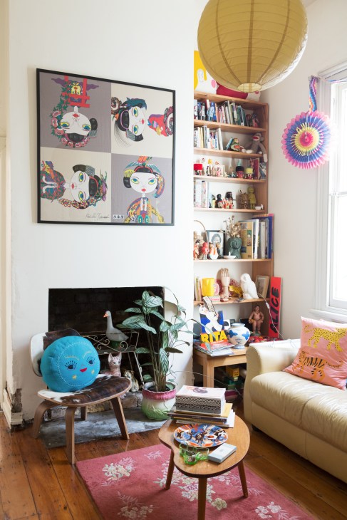 Colourful living room with mid-century furniture, shelving, artwork and decorative objects belonging to Alice and Lucy Oehr.