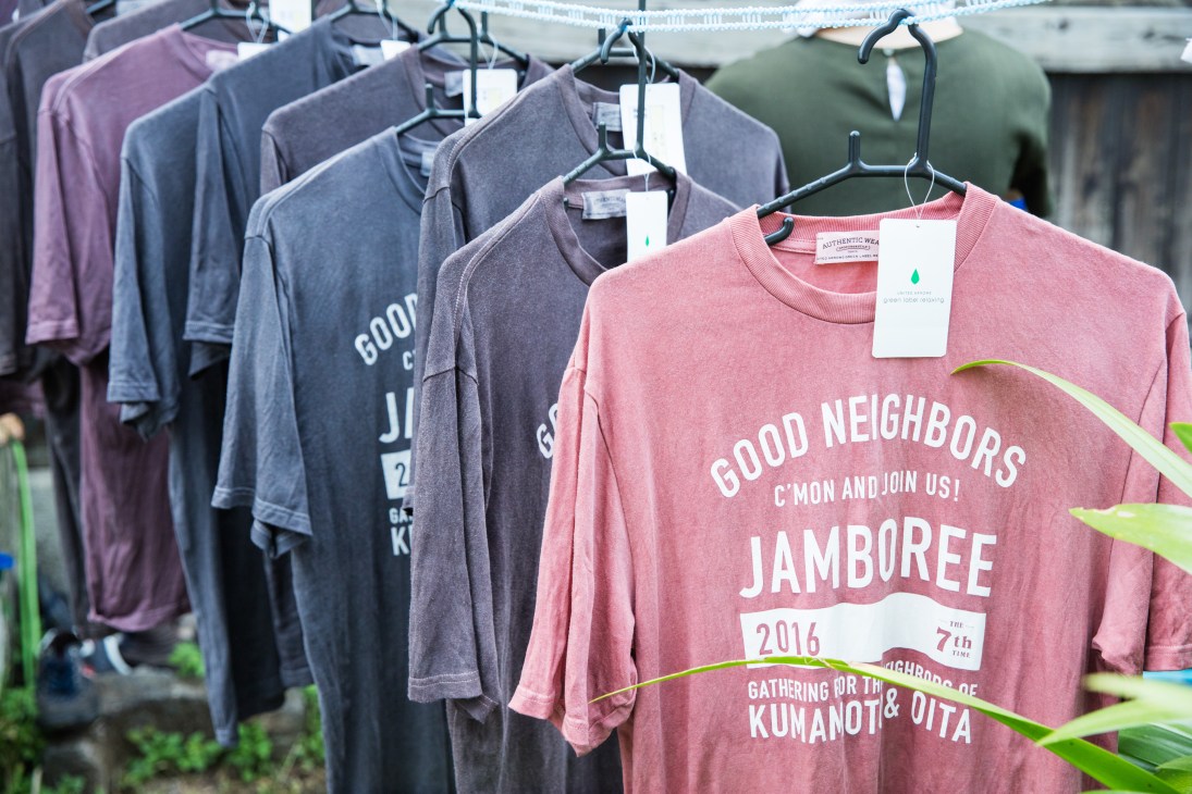 Good Neighbors Jamboree merchandise t-shirts hanging on display at the event.