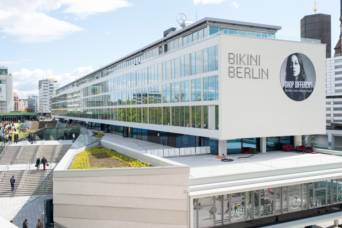 Exterior of Bikini Berlin concept mall with 'Shop Different' signage and surrounding Berlin cityscape.