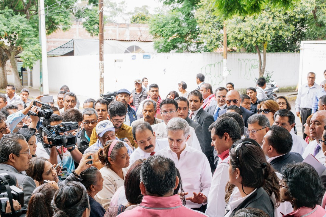 Mayor Miguel Ángel Mancera surrounded by media and attendees at a public health event promoting doctor house calls.