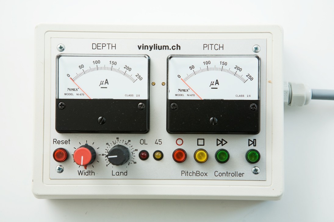 Vinylium lathe computer control panel with depth and pitch gauges, buttons and switches.