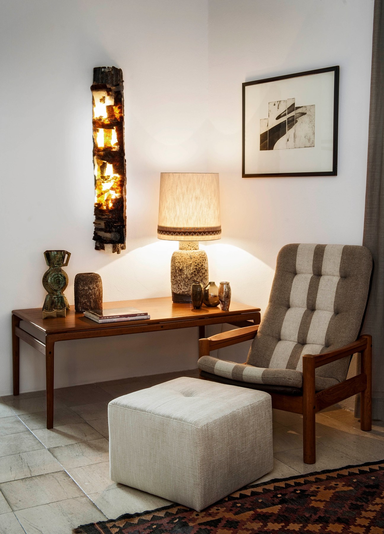 Interior display at Pátria Interiores shop featuring mid-century furniture, lighting and decorative objects.