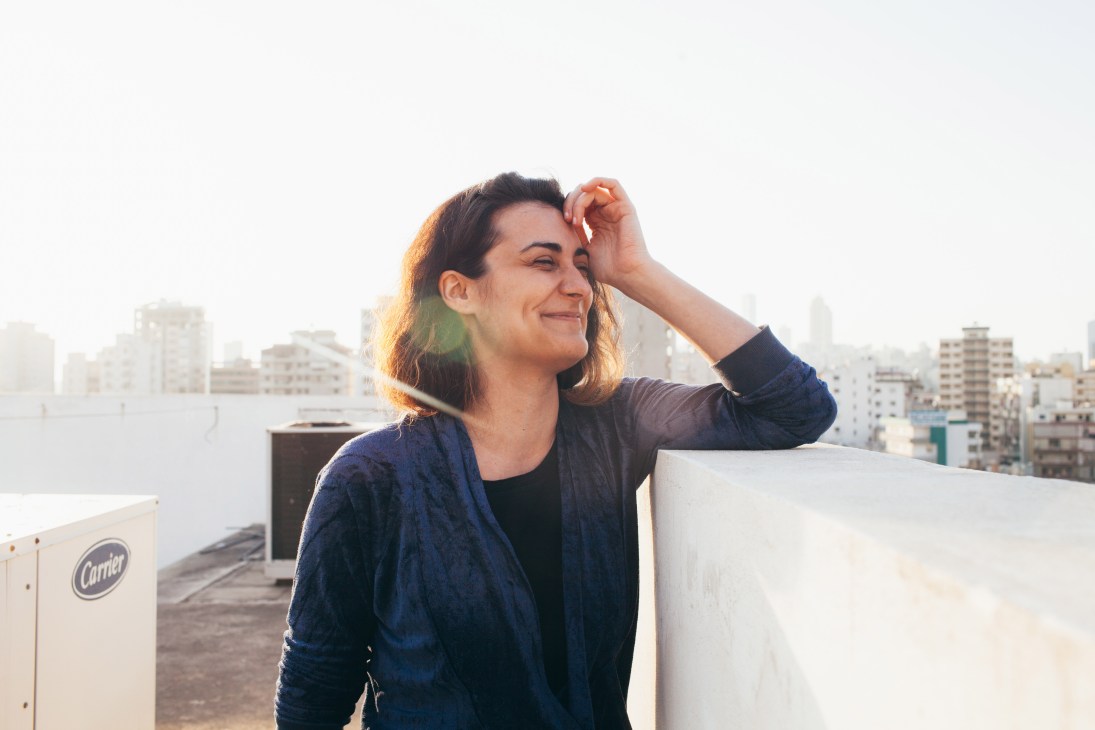 Emilie Duval, director of Alba's fashion school, stands on a rooftop overlooking Beirut's cityscape.
