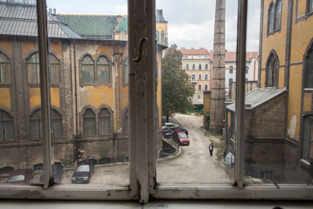 Budapest cityscape with historic buildings viewed through an open window at Moholy-Nagy University of Art and Design.
