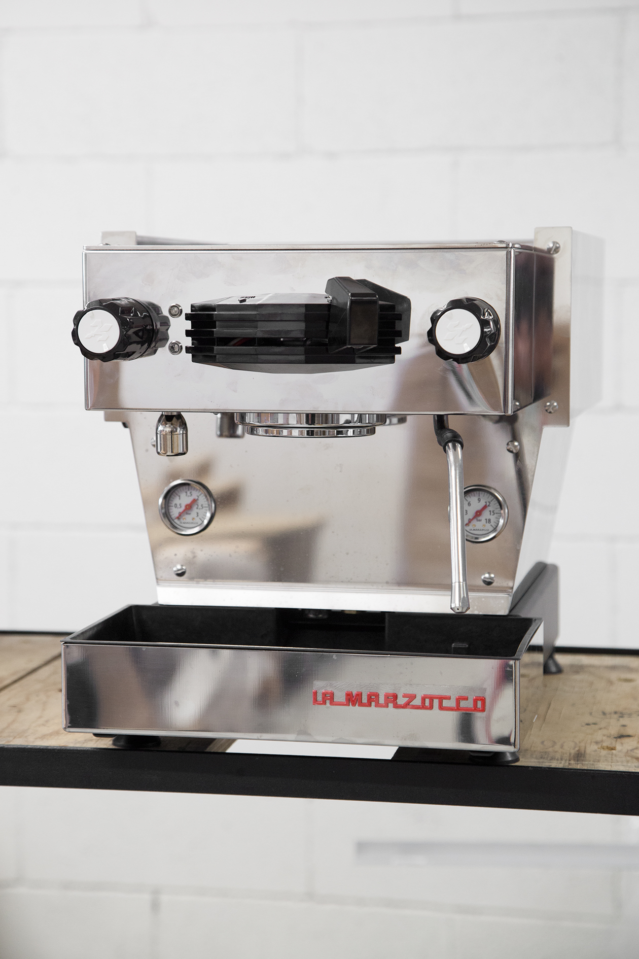 La Marzocco Linea Mini espresso machine with stainless steel body, black portafilter and controls.