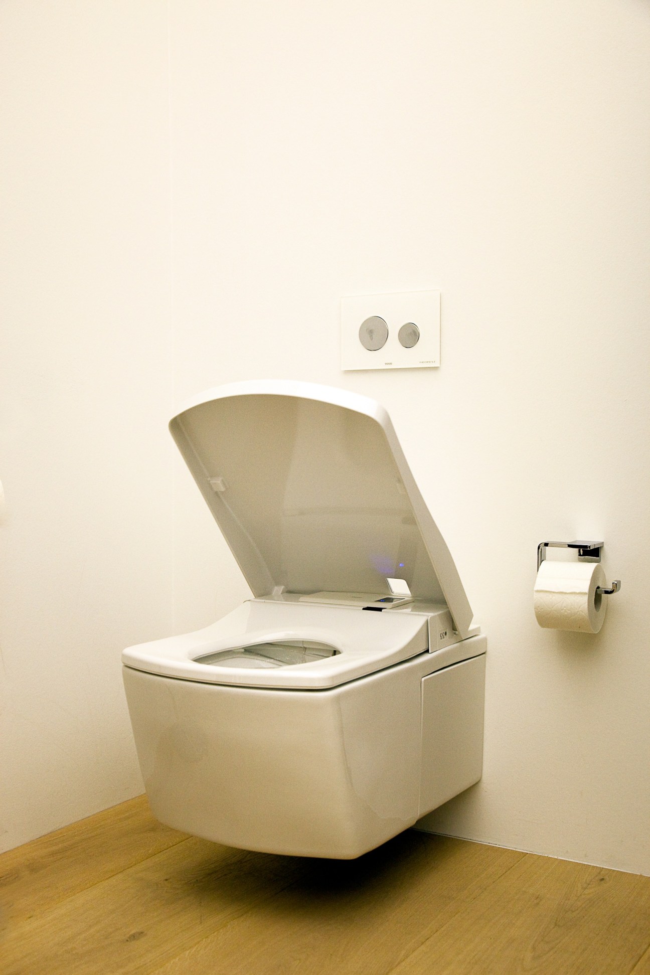 Toto Neorest LE toilet with sleek white design and open lid in gallery setting.