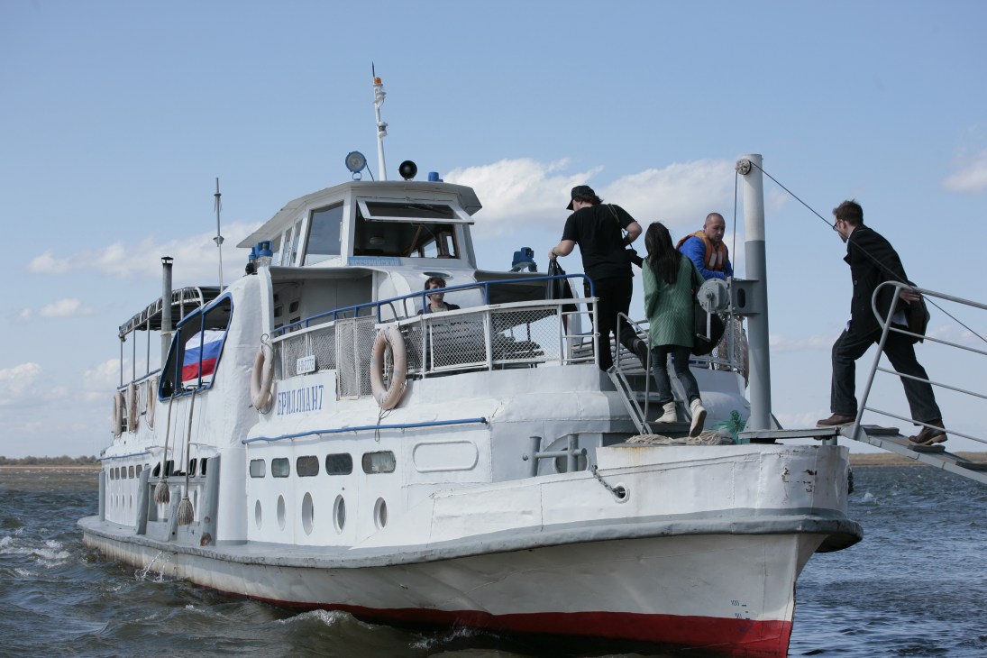Passengers board a white and red ferry departing from Khabarovsk for Bolshoi Ussuriisk island.