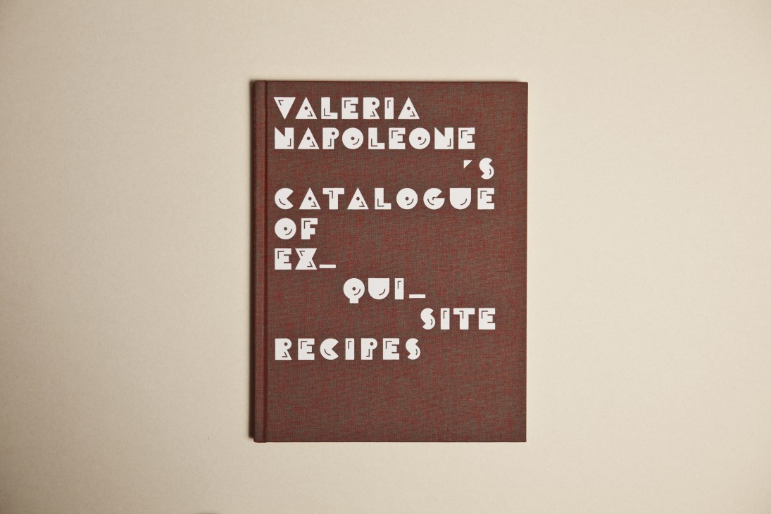 Book cover of Valeria Napoleone's Catalogue of Exquisite Recipes with burgundy cloth binding and white geometric typography.