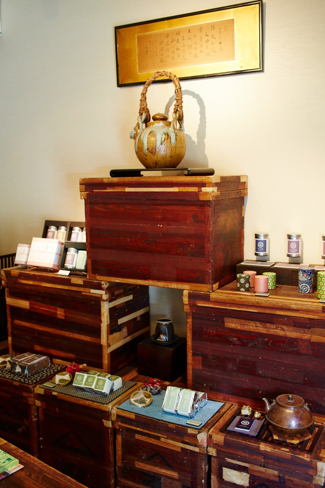 Interior of Maruni tea shop displaying wooden storage boxes and tea products on shelves.