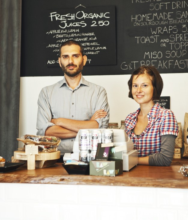 Marco Tassone and Ilaria Giovannini, owners of G&T organic coffee house and store in London, stand behind their counter.