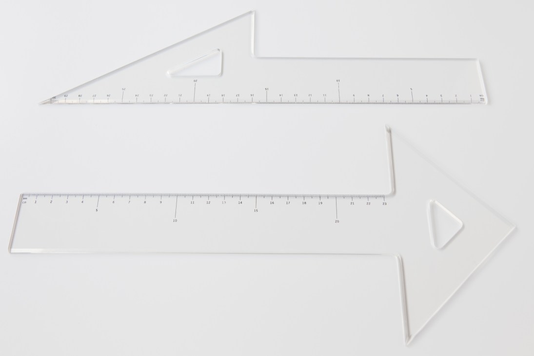White stationery items by Sosuke Nakabo including rulers and set squares with precise measurements and geometric shapes.