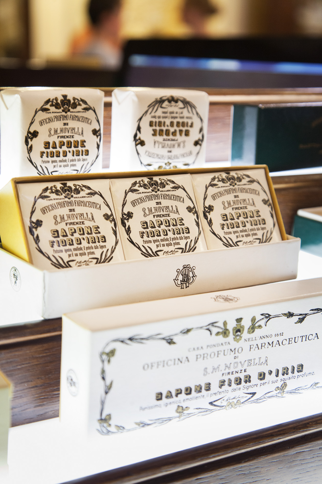 Packaged soaps from Officina di Santa Maria Novella displayed in a white wooden box at the Florence apothecary.
