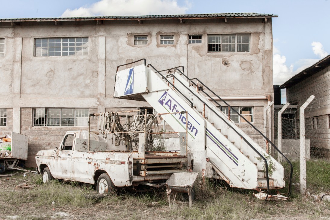 Weathered African Express airline equipment and stairs at Nairobi airport headquarters.