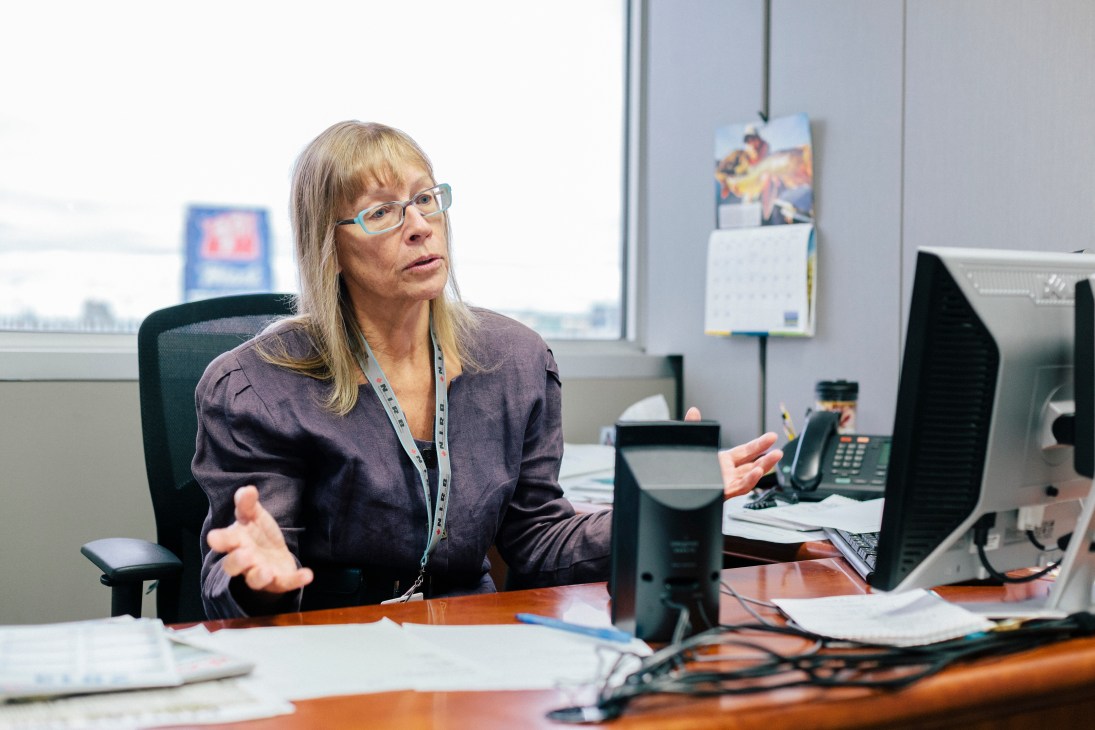 Janice Stein, CBC North managing director, sitting at her desk speaking during an interview.