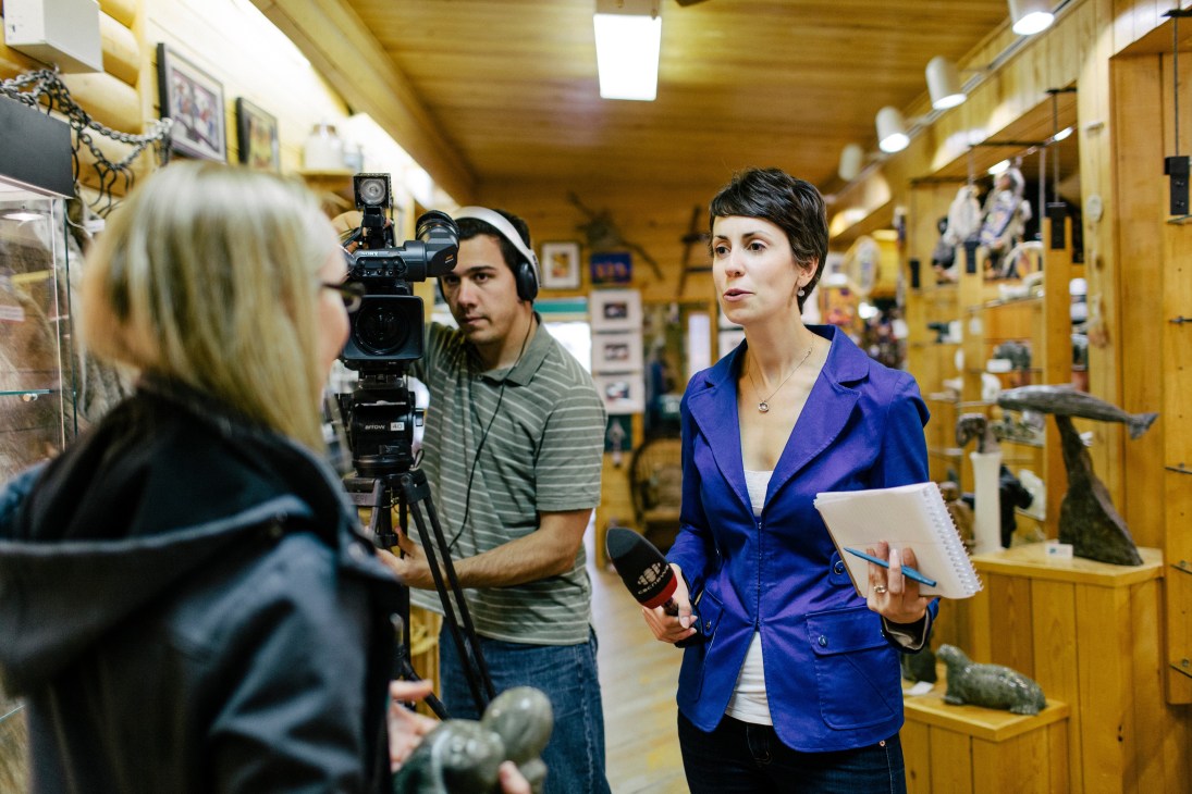 CBC North reporters Robyn Burns and Mitch Wiles film an interview at Gallery of the Midnight Sun in Yellowknife.