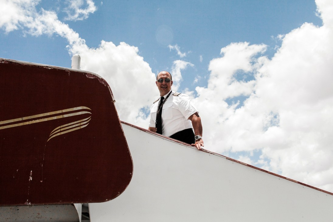 Captain Gamero in pilot uniform boarding African Express aircraft at Hargeisa airport