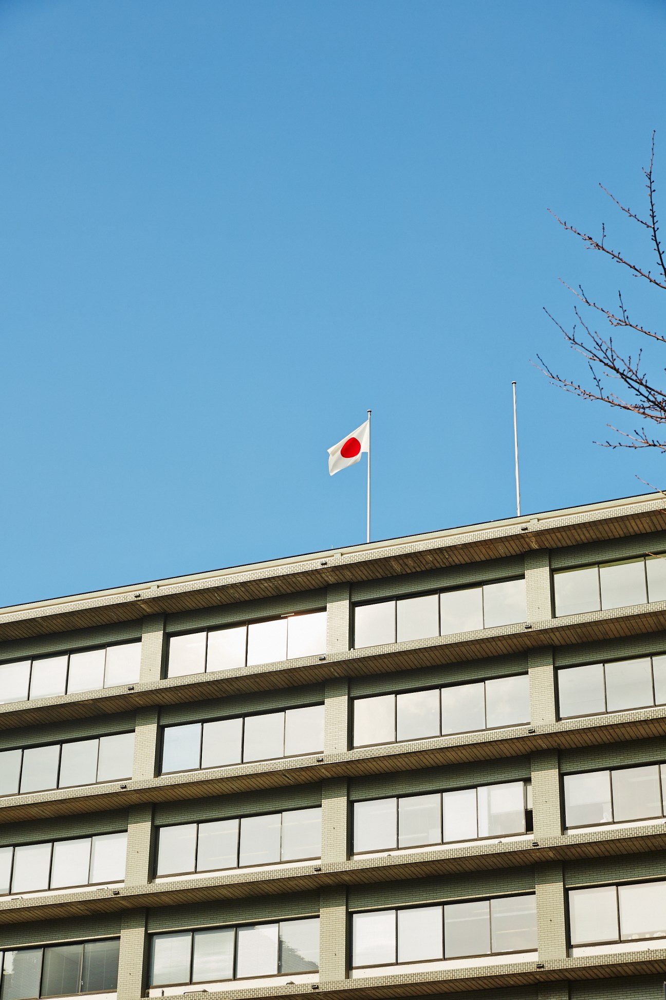 Japanese flag flying above the Ministry of Foreign Affairs headquarters building in Tokyo.