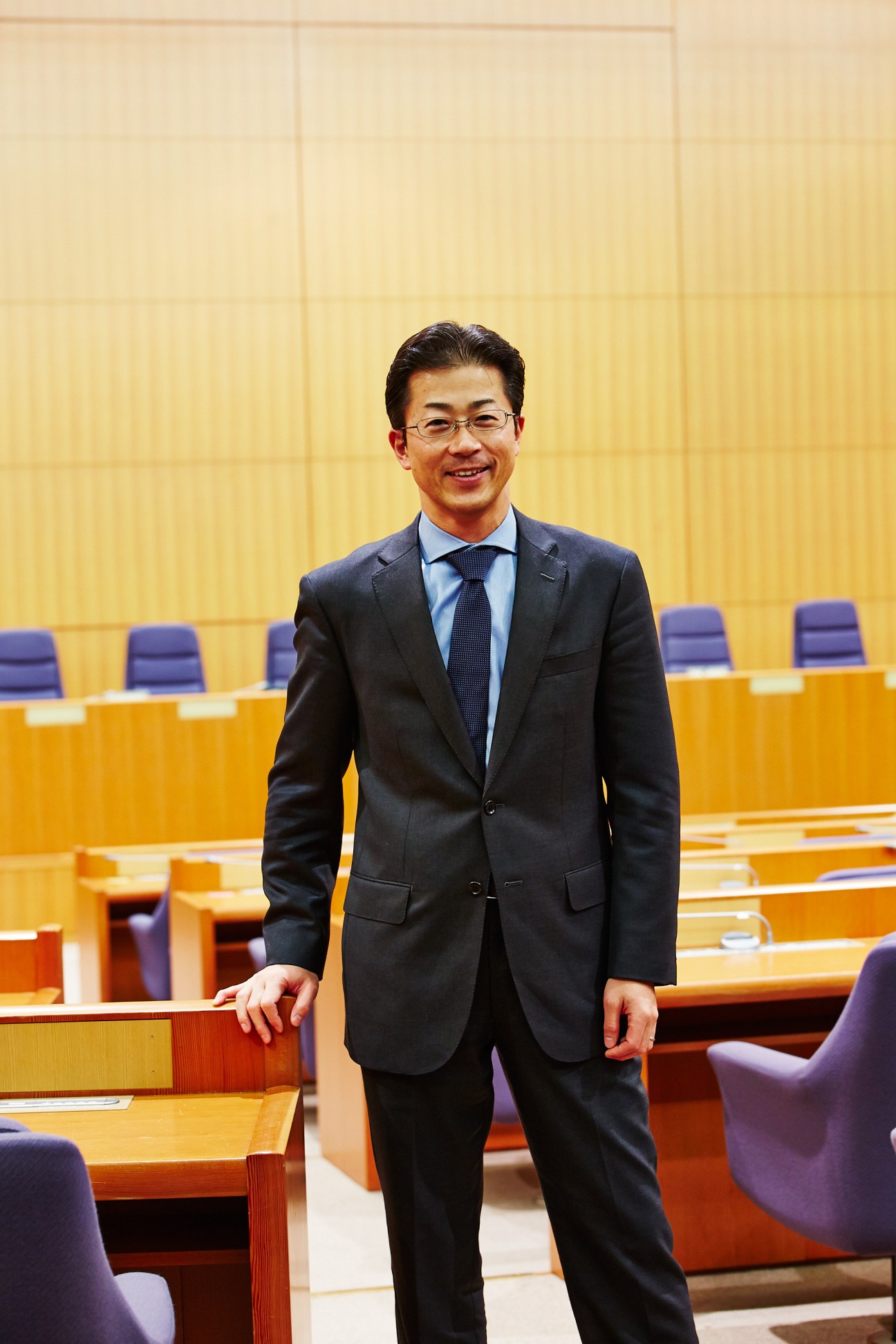 Toshihiro Kitamura, director of Japan's Foreign Ministry western Europe division, stands in a modern conference room.