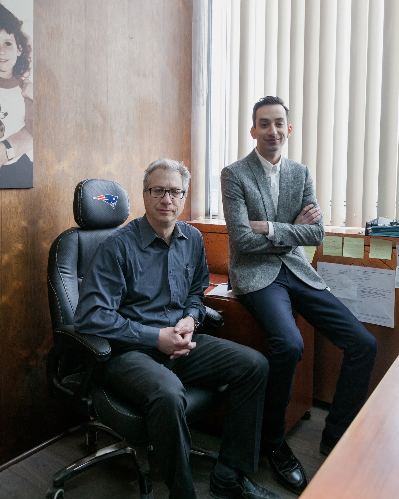 Sonni and Brandon Svarc, co-founders of Naked & Famous denim brand, posing in an office.