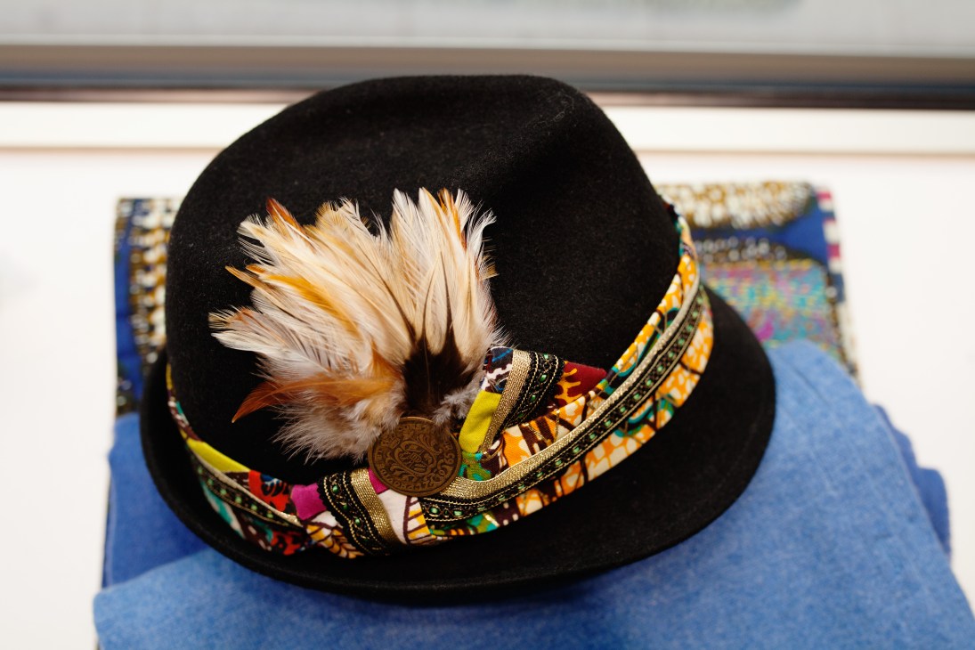 Black felt hat with feather plume and colorful embroidered band by Munich designer Rahmée Wetterich