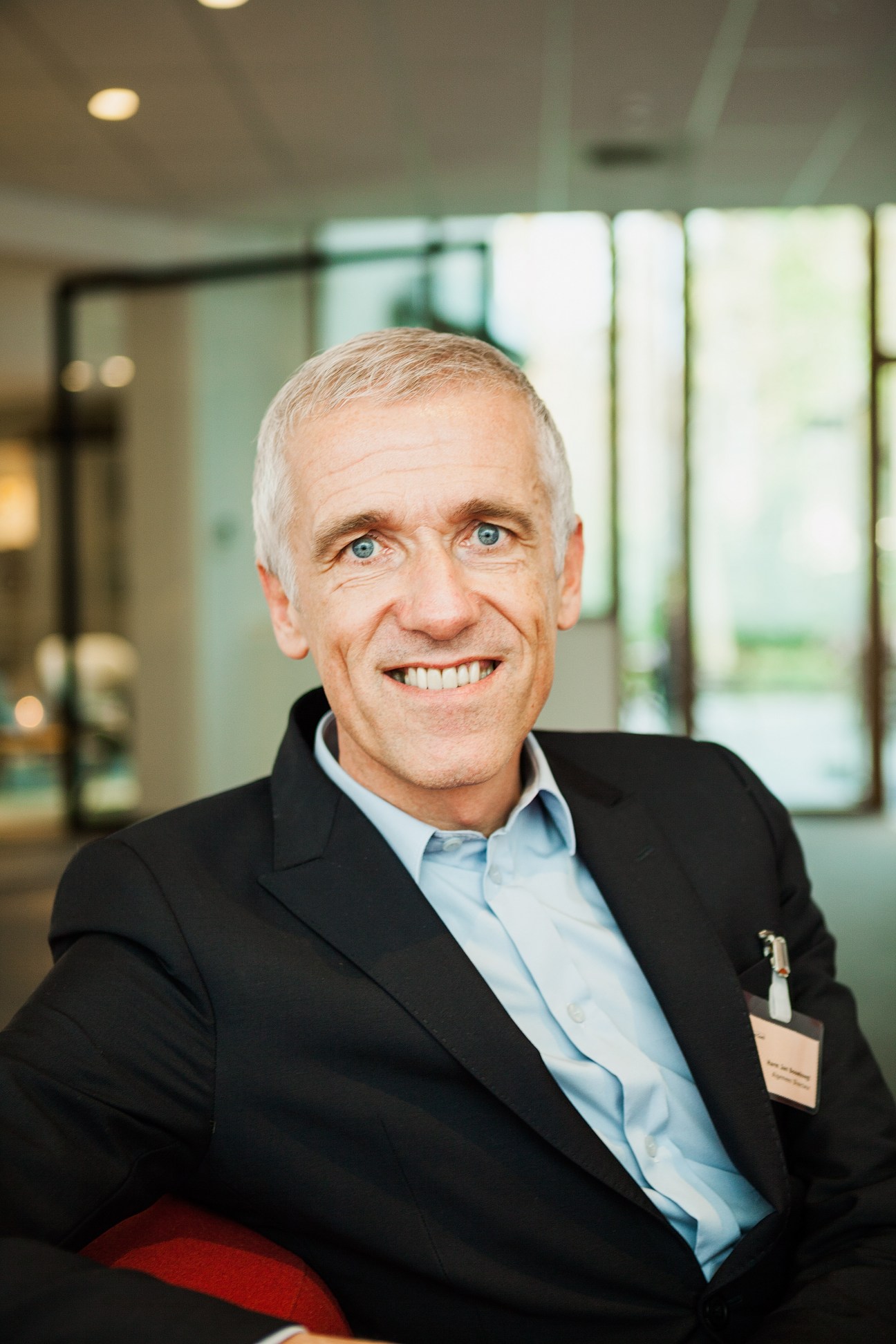 Harm Jan Bouwknegt, managing director of Regina Coeli language institute, smiling in a modern office setting.
