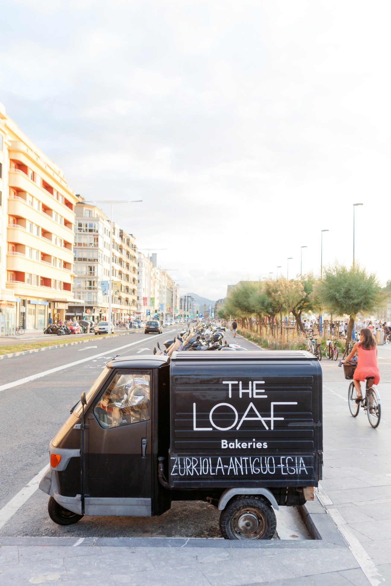 The Loaf bakery delivery vehicle parked on a San Sebastián street with pedestrians and buildings visible.