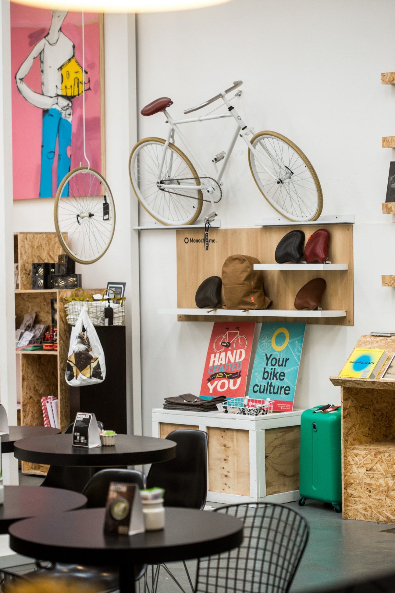 Interior of Editor Market Buenos Aires showing displayed bicycles, leather goods, and colorful signage.