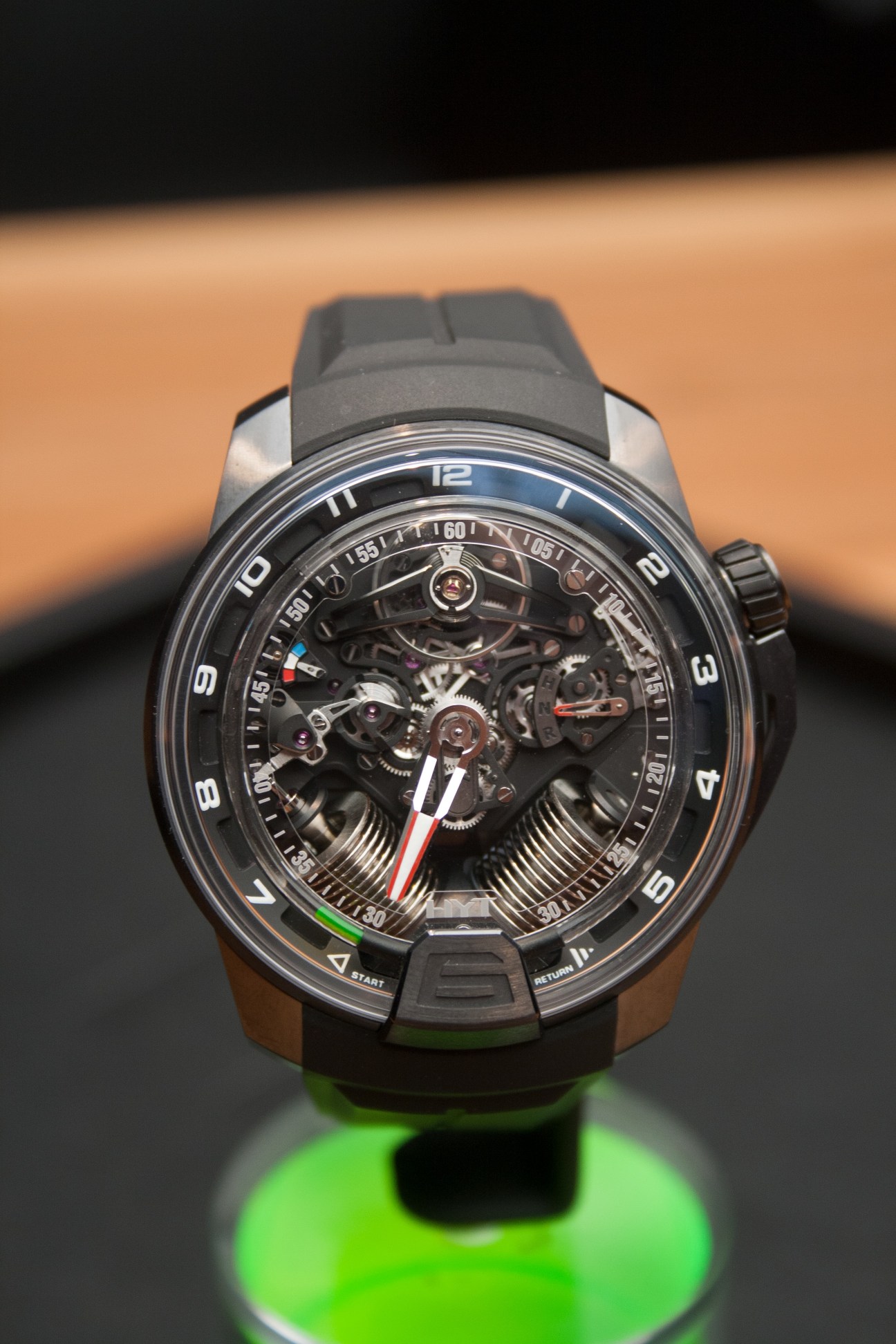 HYT H2 mechanical watch with exposed skeleton movement and liquid time indicators on rubber strap.