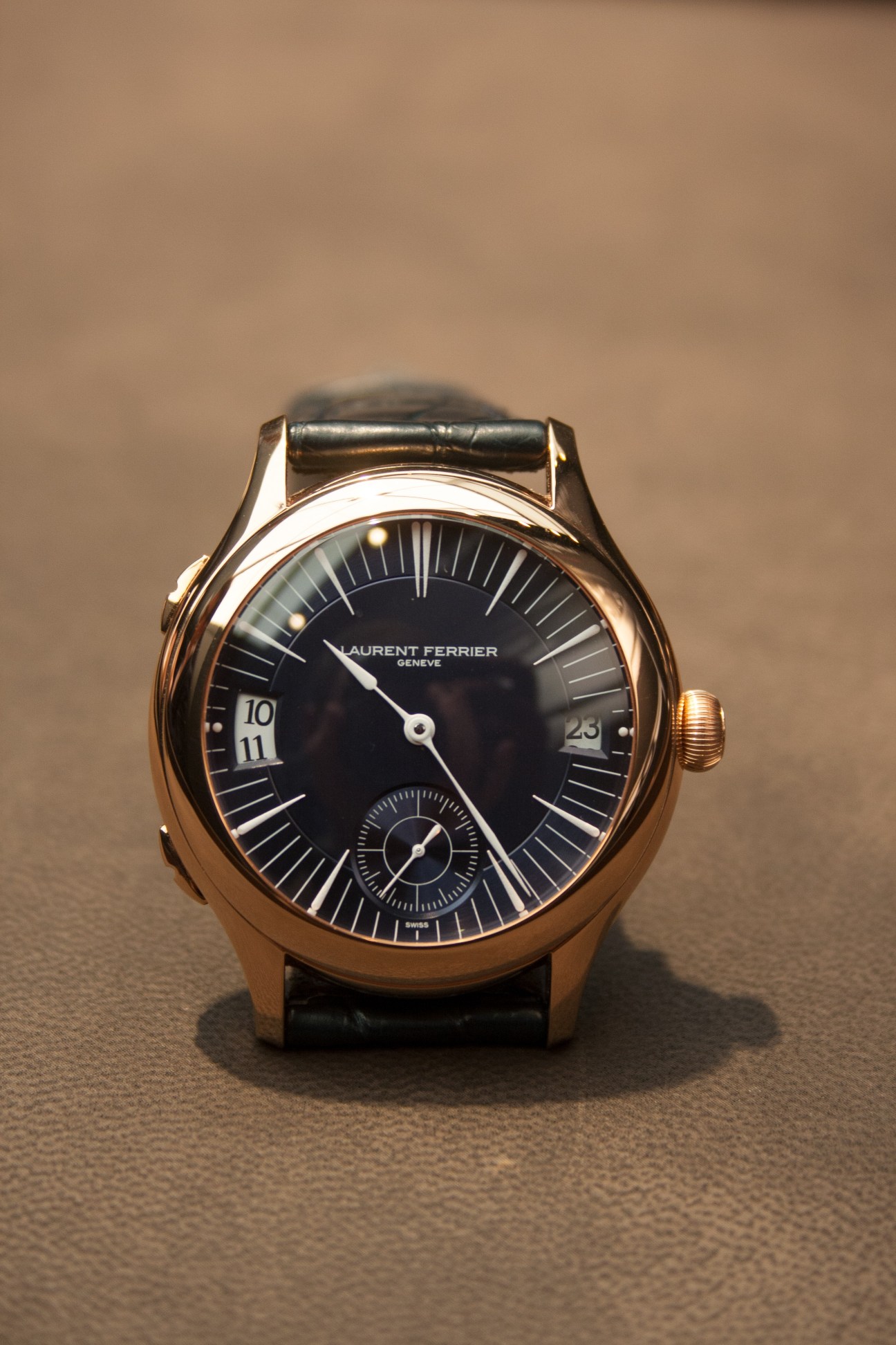 Laurent Ferrier Galet Traveller watch with rose gold case, black dial, and dual-time display aperture.