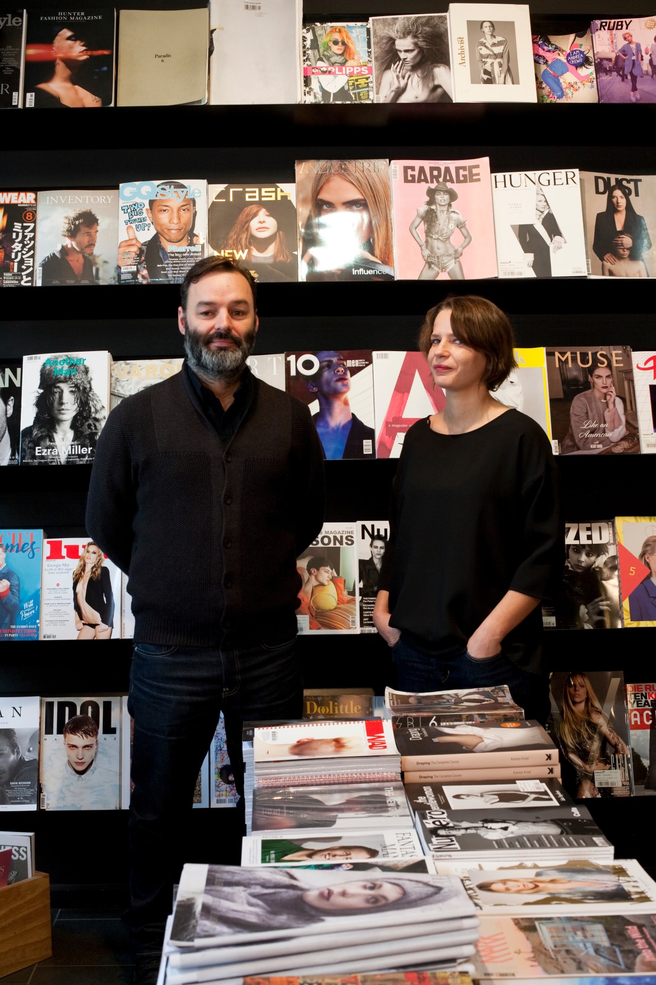 Two people stand in front of shelves displaying magazines and publications at Do You Read Me?! bookstore in Berlin.