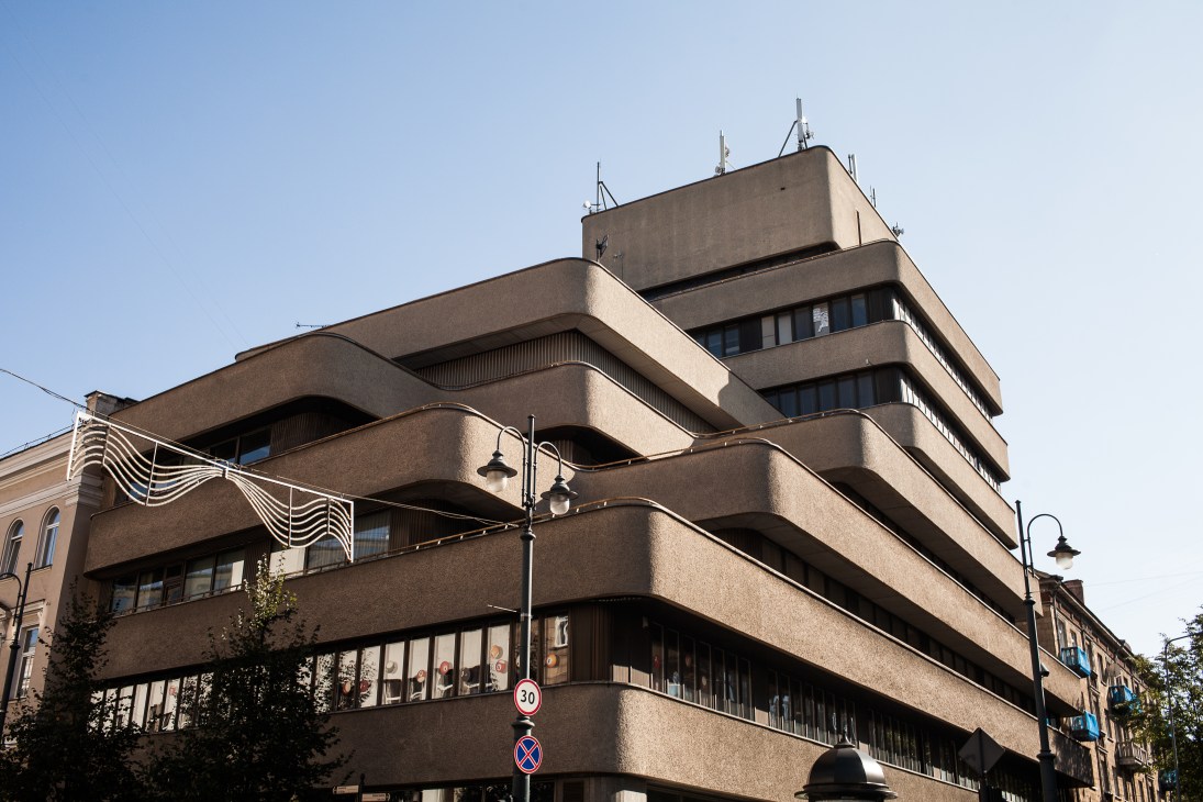 Brutalist concrete building with stacked horizontal balconies and antenna in Vilnius