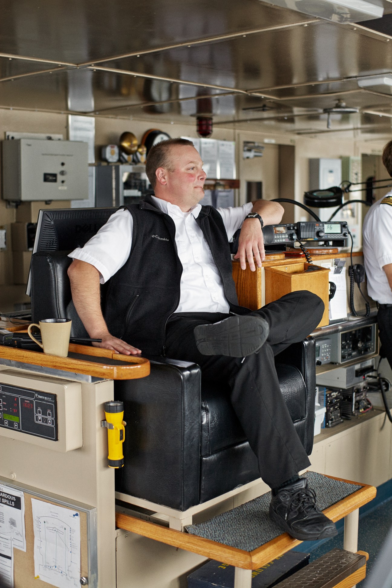 Captain Ken Grieser sits in the captain's chair on the bridge of the M/V Columbia ferry.