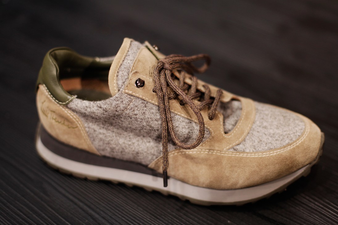 Wool-and-suede trainer by Luis Trenker with cream suede and grey wool upper on dark surface