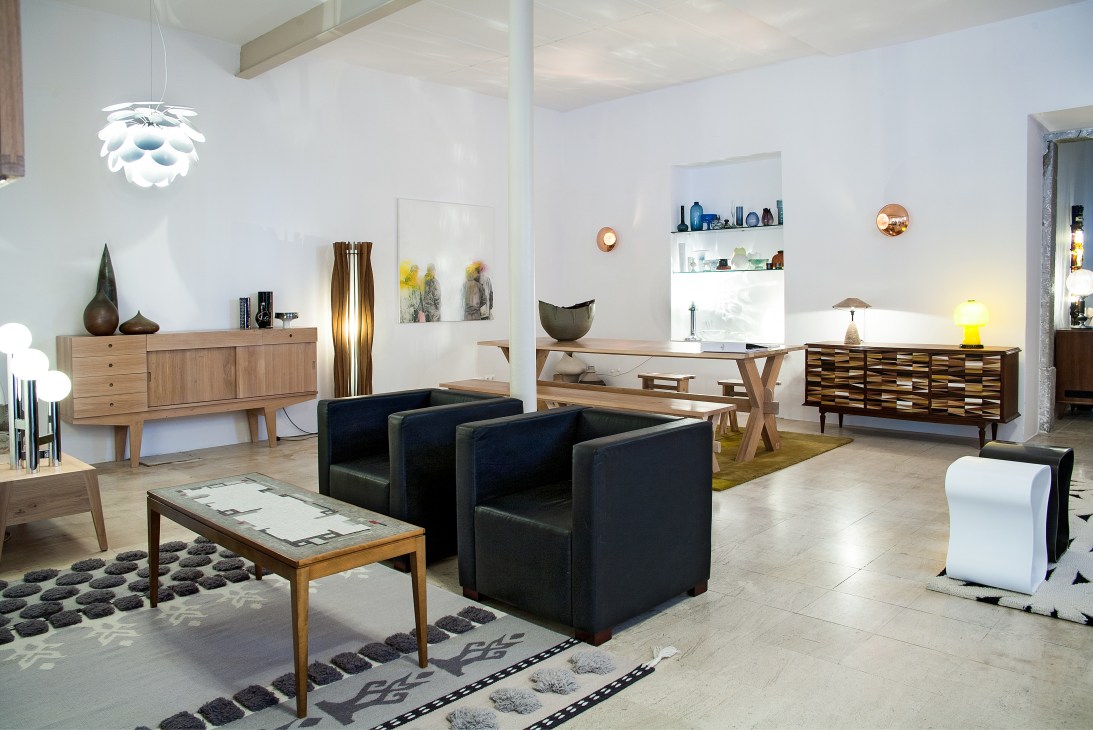 Interior of Pátria Interiores shop in Lisbon displaying mid-century furniture, lighting, and design objects.